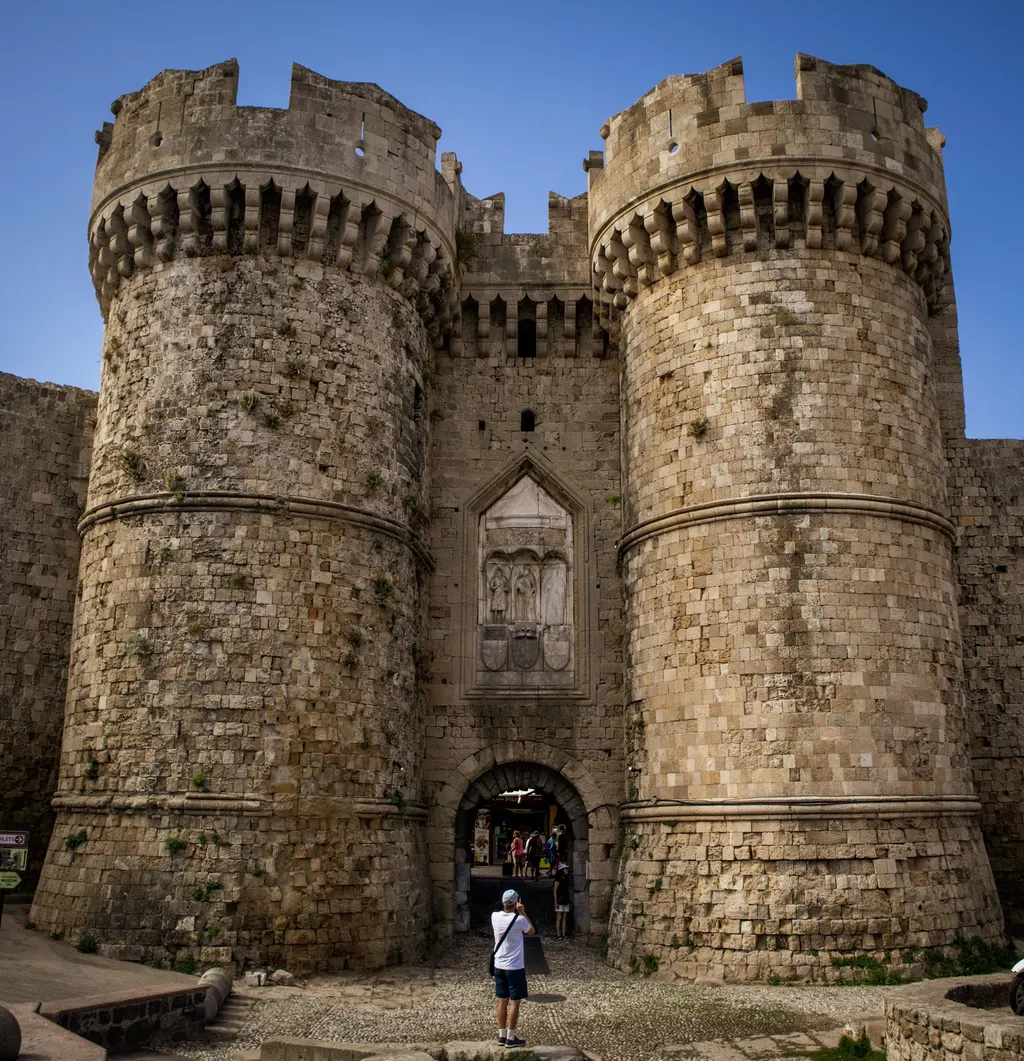 Two massive round medieval towers flanking a gateway in the walls of Rhodes Old Town
