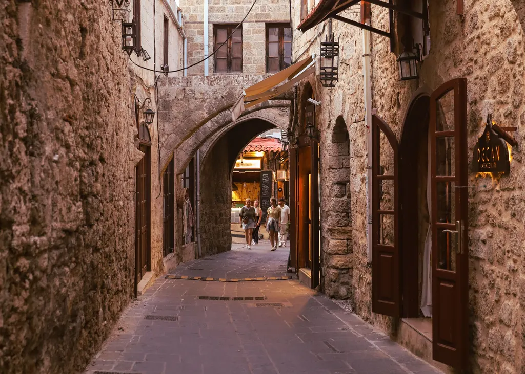 A stone lane with arches and shopfronts in Rhodes Old Town