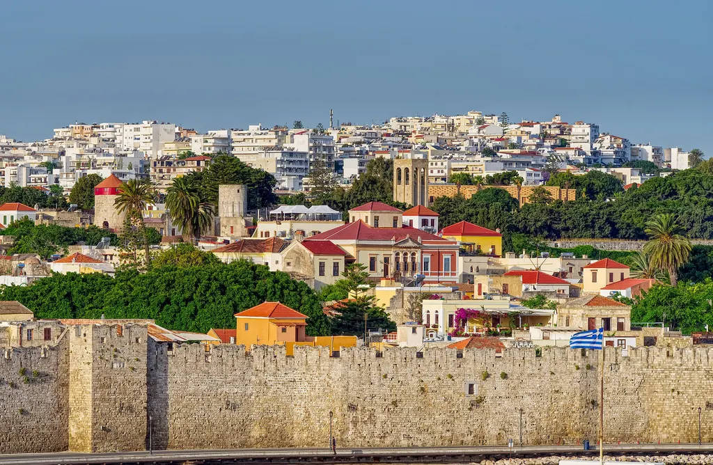 The medieval walls of Rhodes Old Town with the houses of the town rising behind them